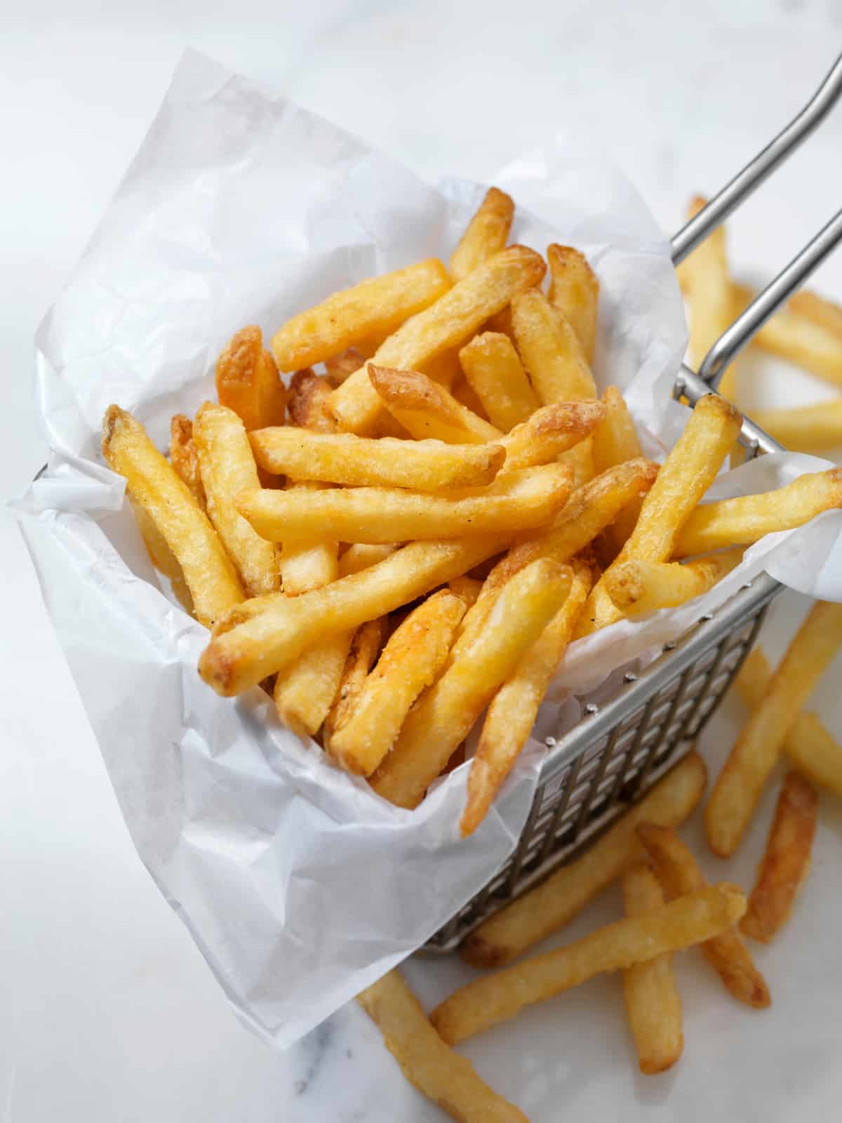 air fried frozen french fries in a bin