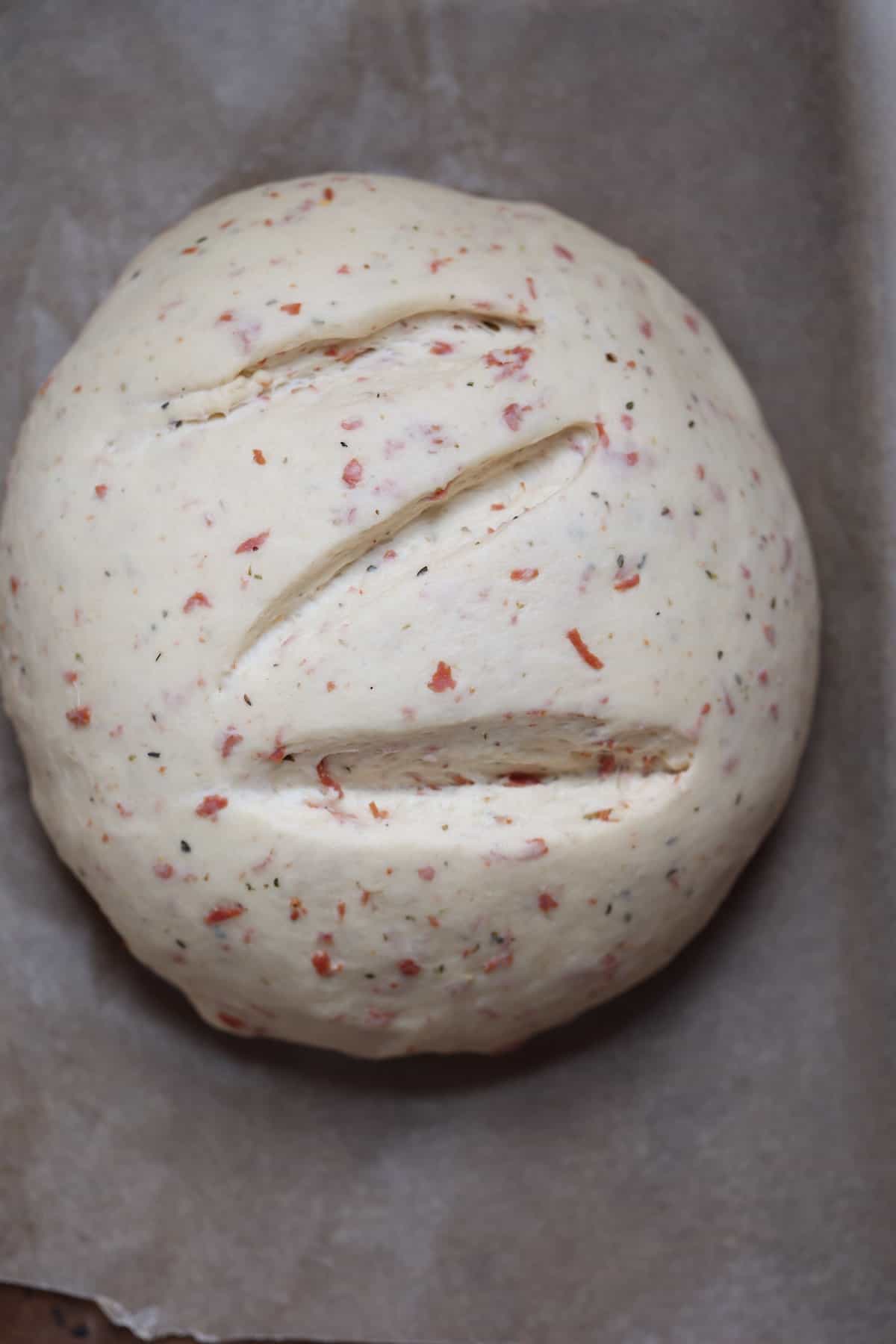 risen dough in a circle shape on a baking sheet