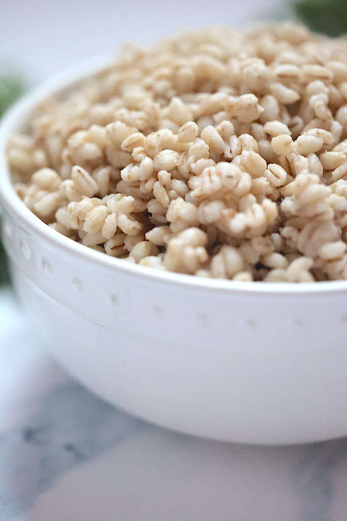 side view of instant pot barley in a white dish