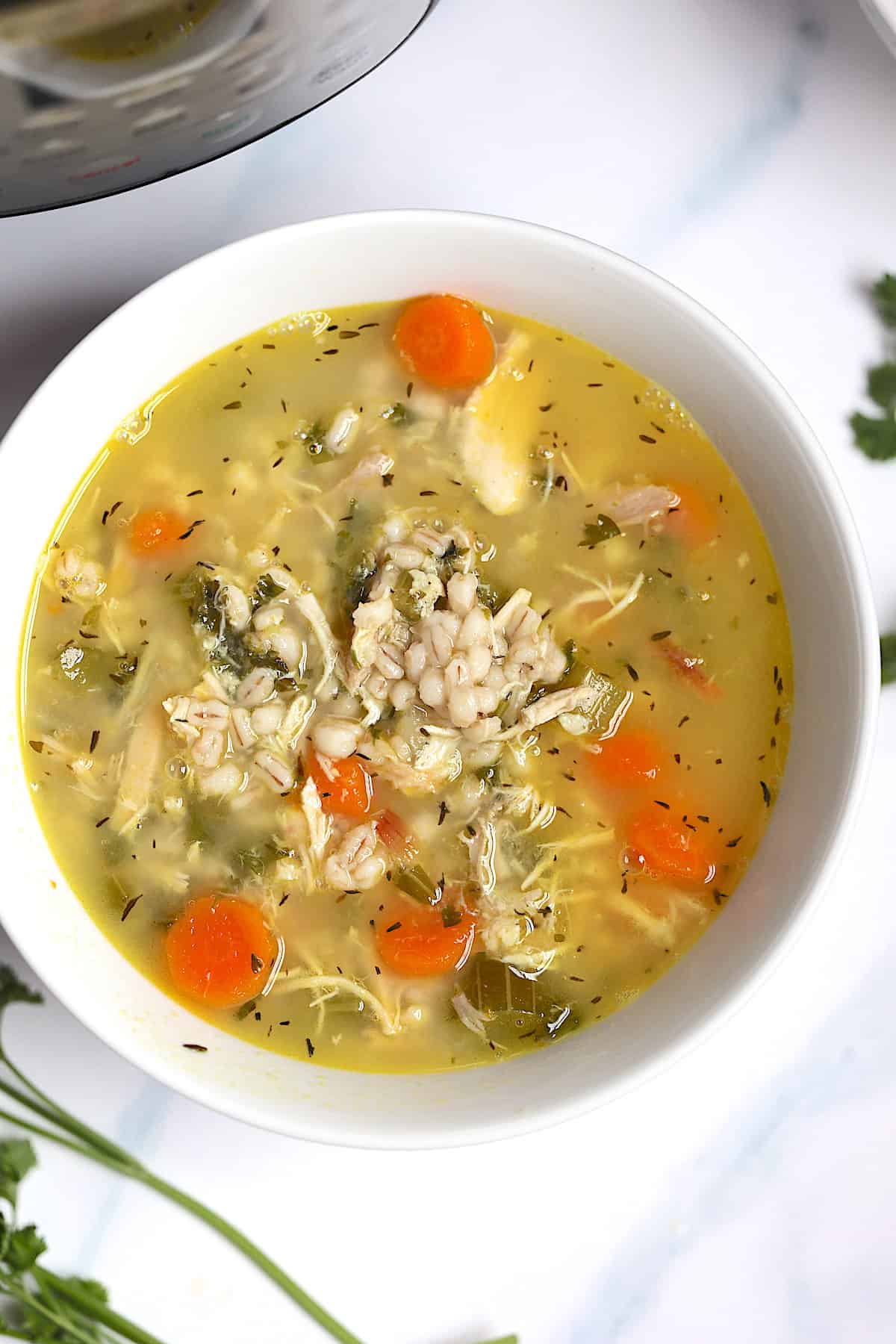 instant pot chicken barley soup in a white bowl