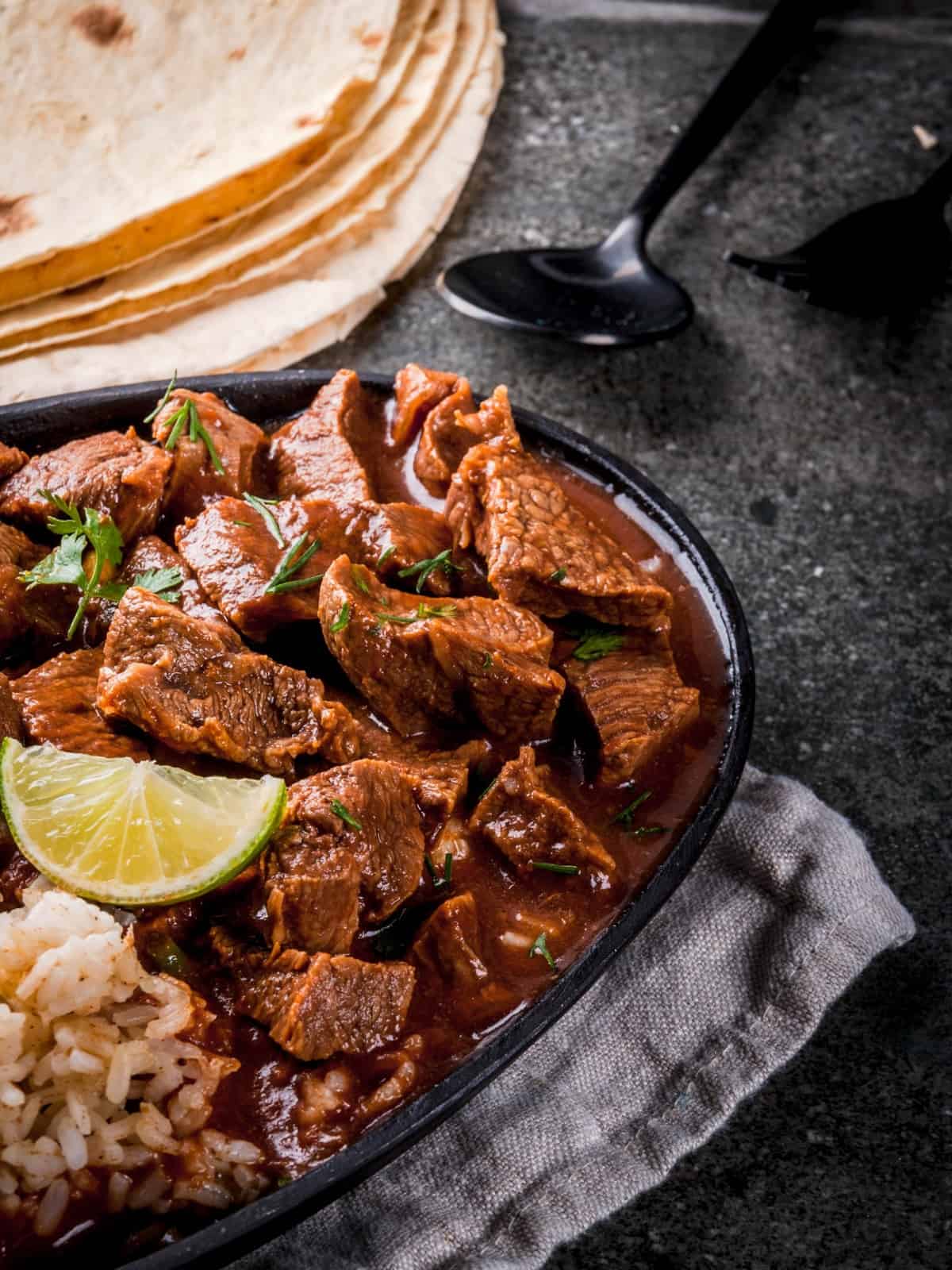 slow cooker chile rojo in a black dish