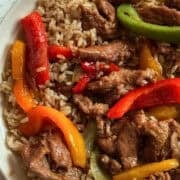 slow cooked peppers, onions and beef in a bowl