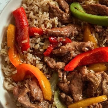 slow cooked peppers, onions and beef in a bowl