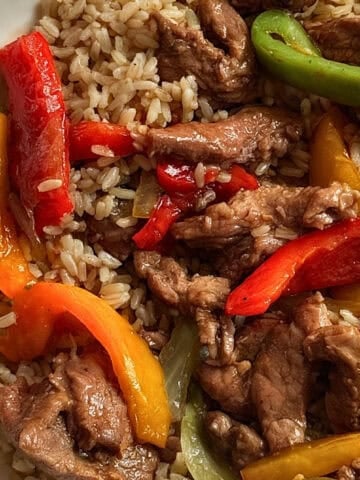 slow cooked peppers, onions and beef in a bowl