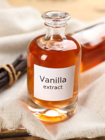 instant pot vanilla extract in a glass bottle on a piece of cloth