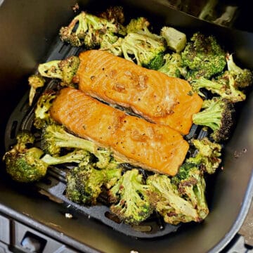 air fryer maple glazed salmon and broccoli in an air fryer basket