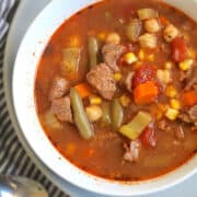 instant pot vegetable beef soup in a white bowl on a gray plate