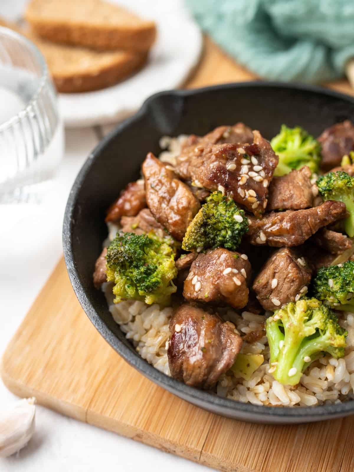 slow cooker beef and broccoli in a black bowl served over rice