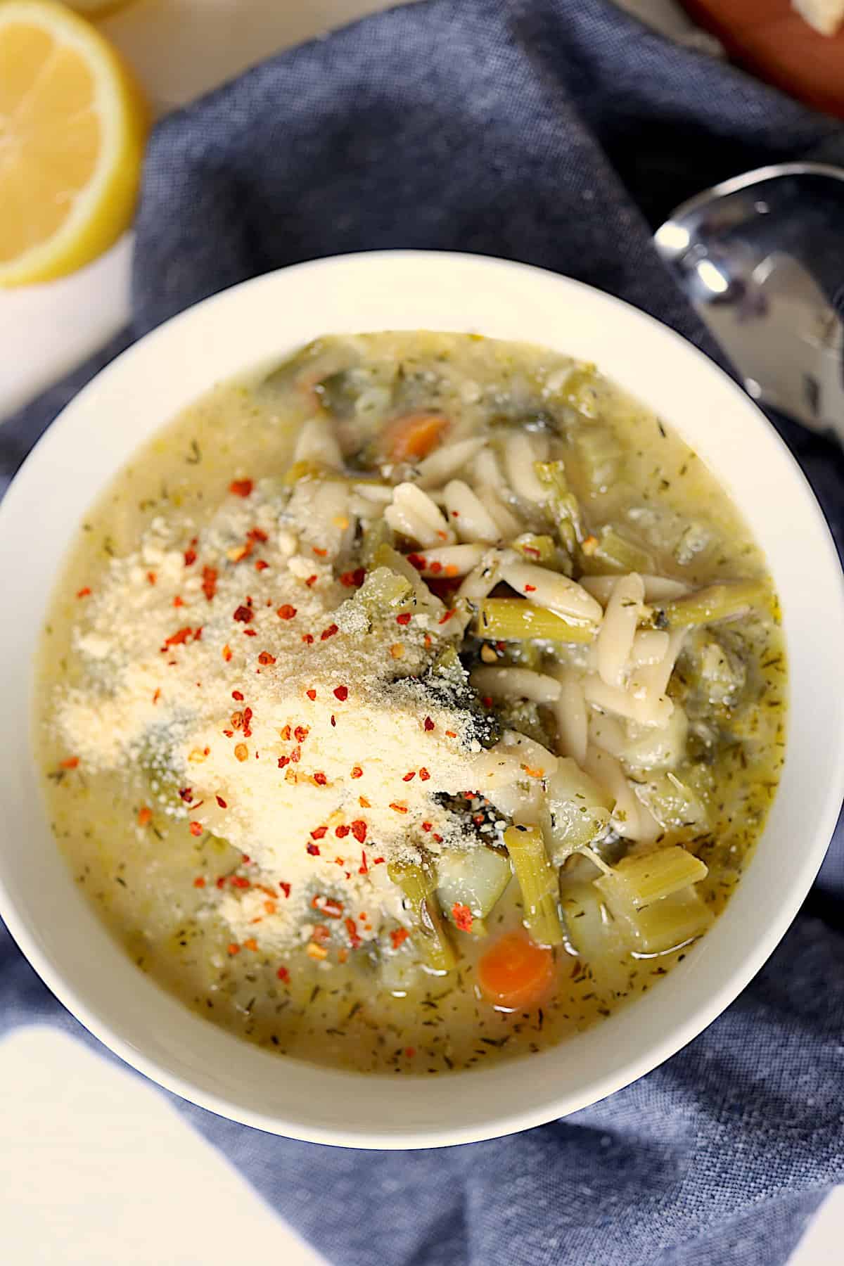 instant pot spring minestrone soup close up topped with parmesan cheese and red pepper flakes