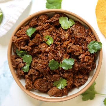 instant pot shredded beef in a bowl topped with cilantro