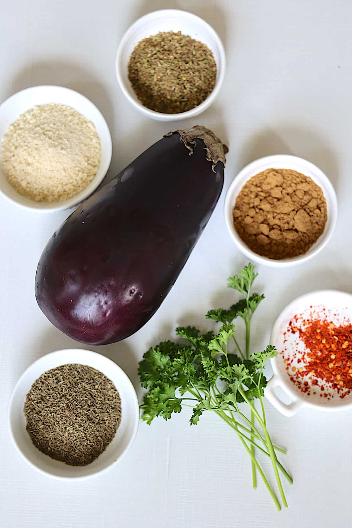 seasonings and eggplant on a white table