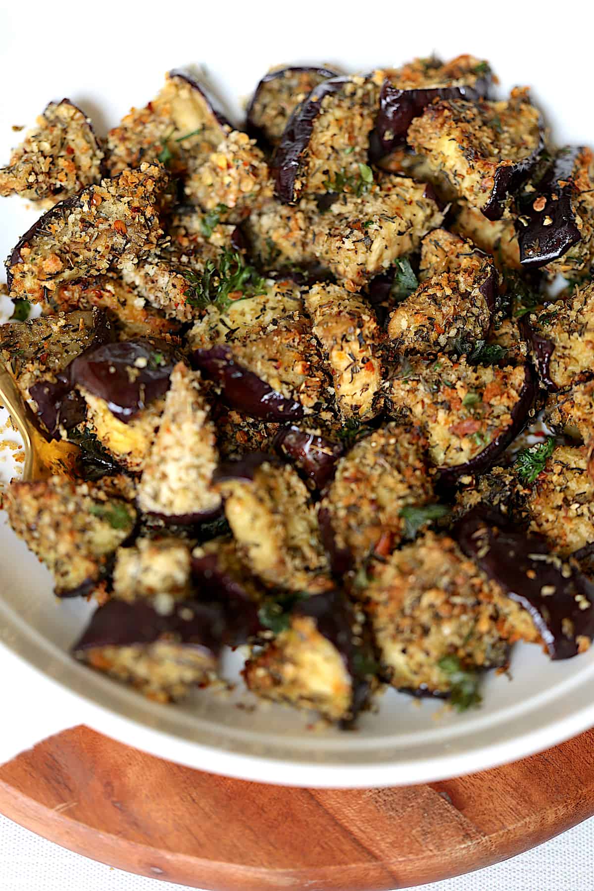 close up of air fried eggplant in a white bowl