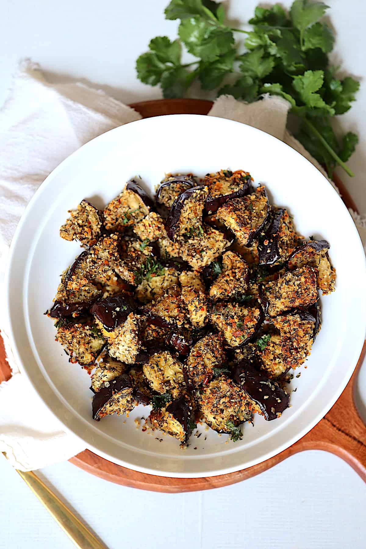 seasoned and breaded air fryer eggplant in a white plate