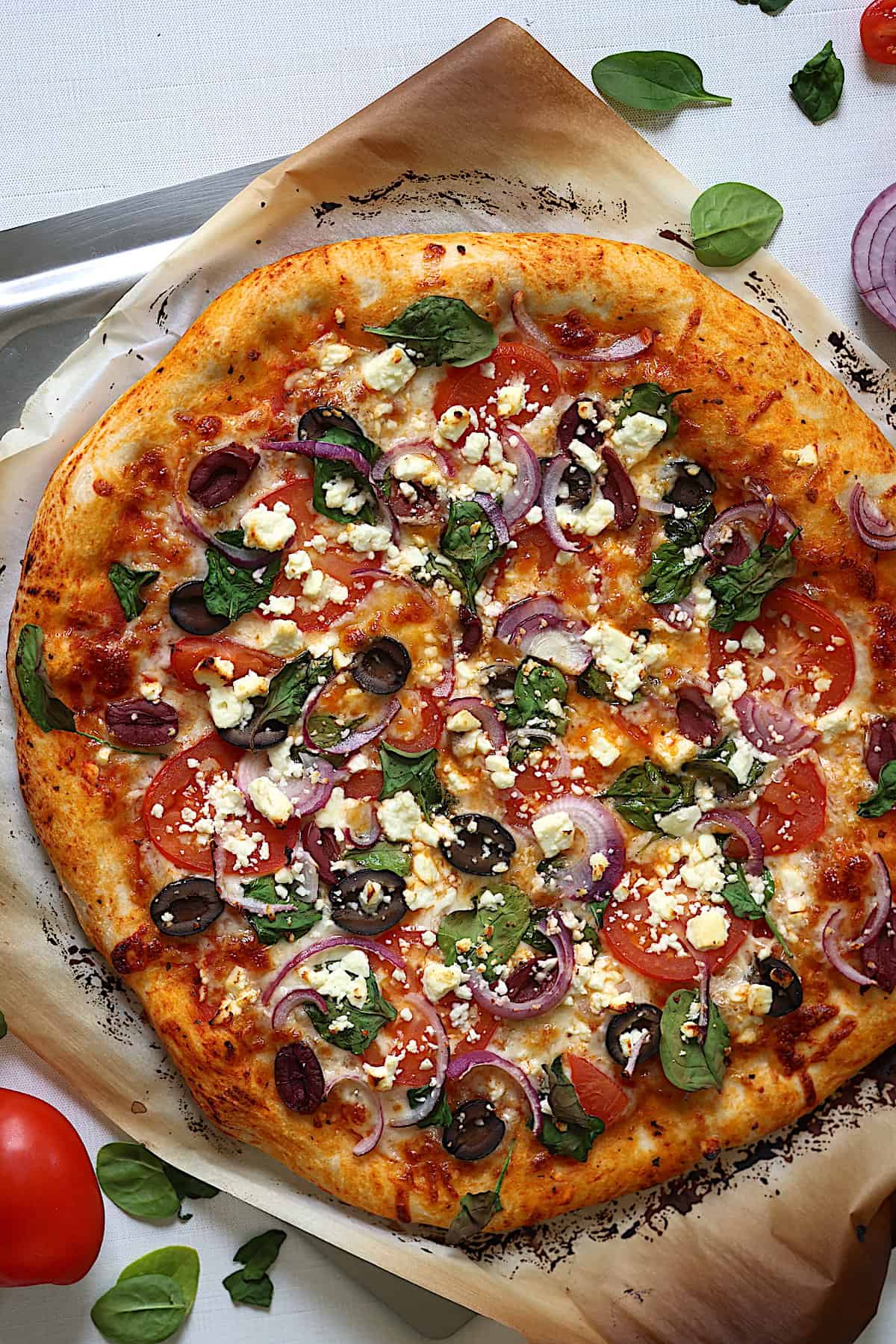 mediterranean pizza on parchment paper