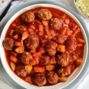 slow cooker lamb meatballs, potatoes and carrots in a white bowl