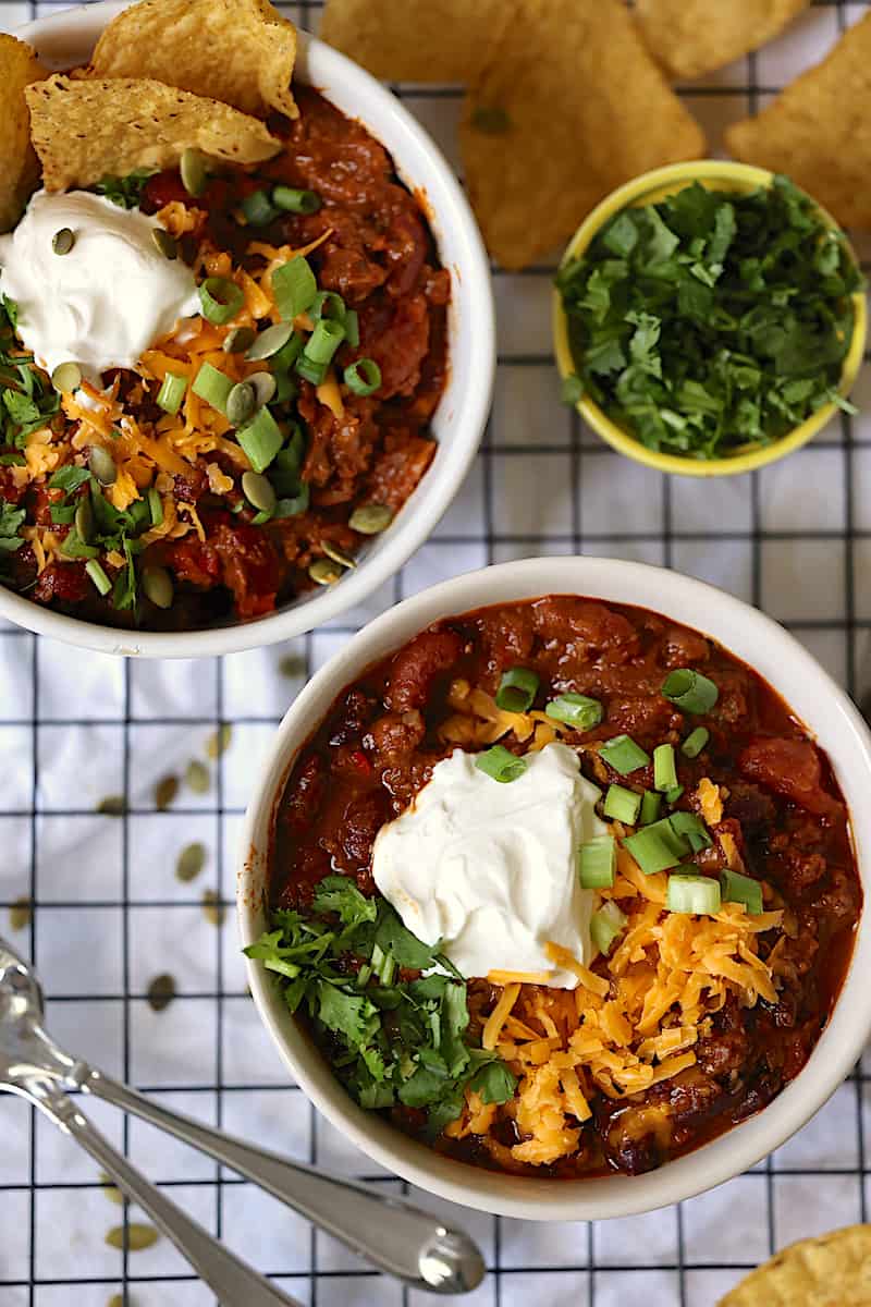 instant pot pumpkin chili in bowls with toppings