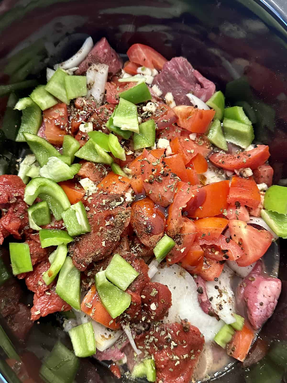 chopped vegetables and meat in a crockpot