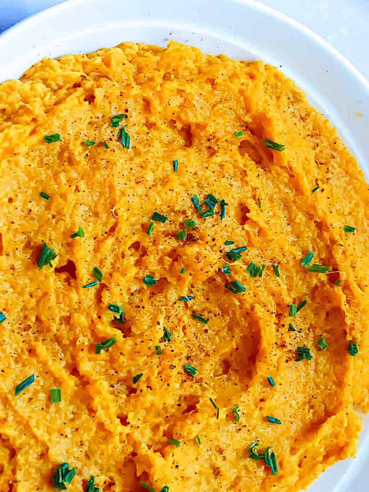instant pot mashed sweet potatoes topped with herbs