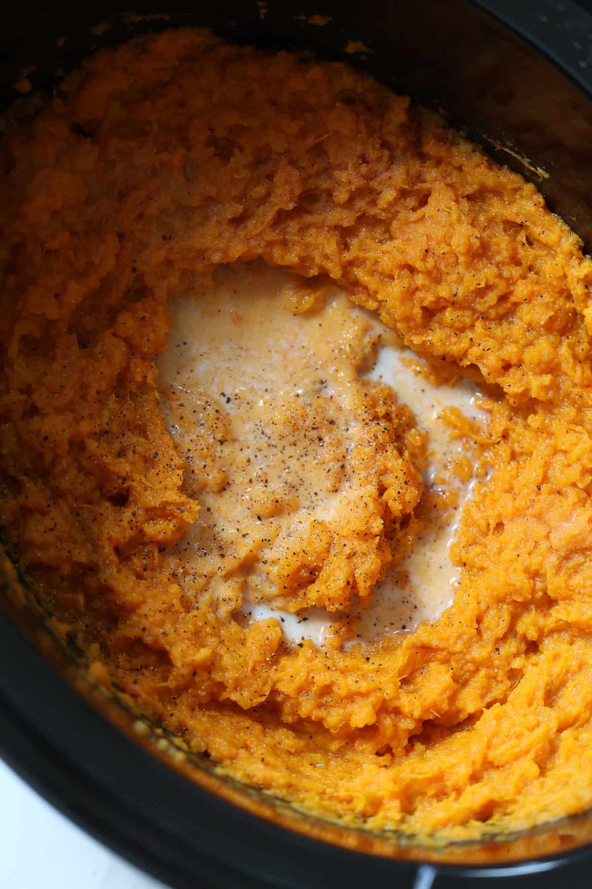 mashed sweet potatoes with butter in a crock pot
