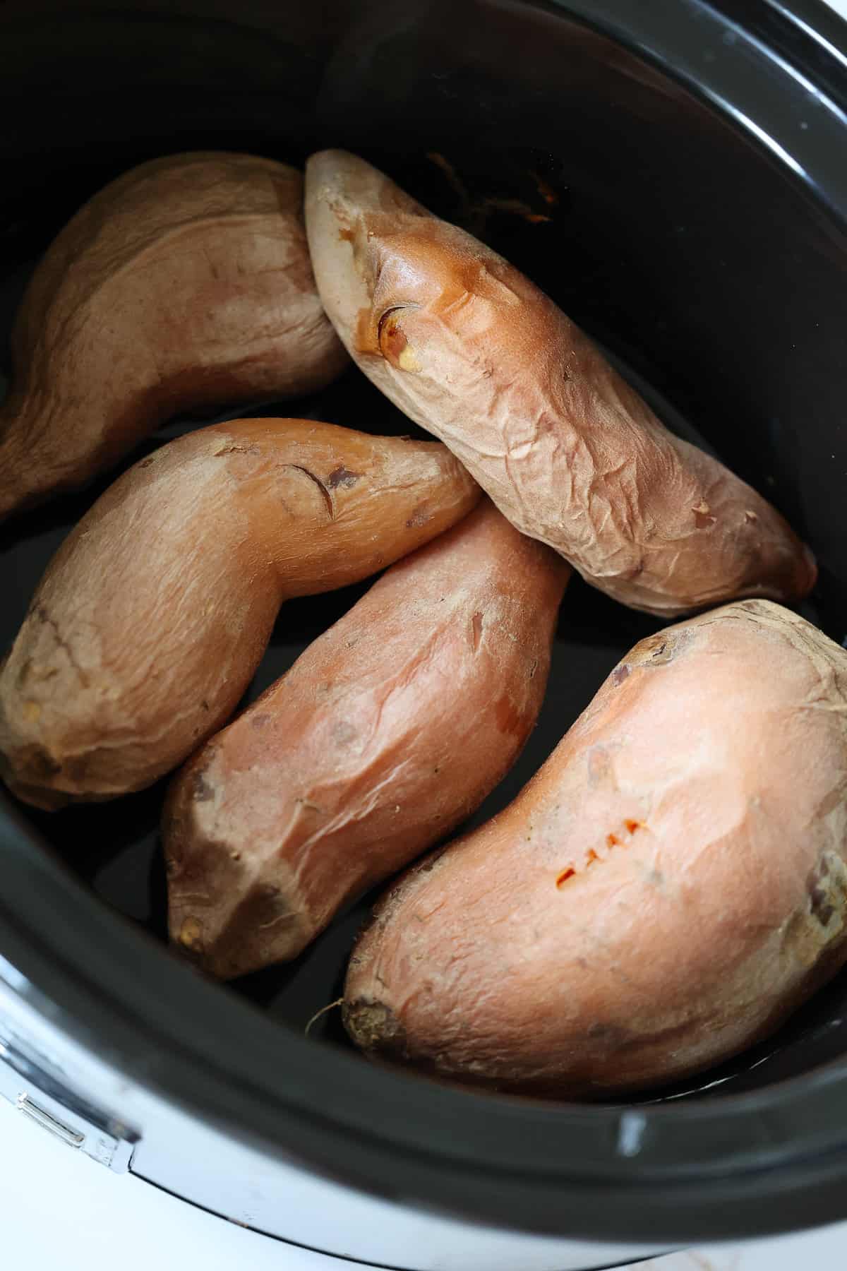 whole sweet potatoes in a crockpot