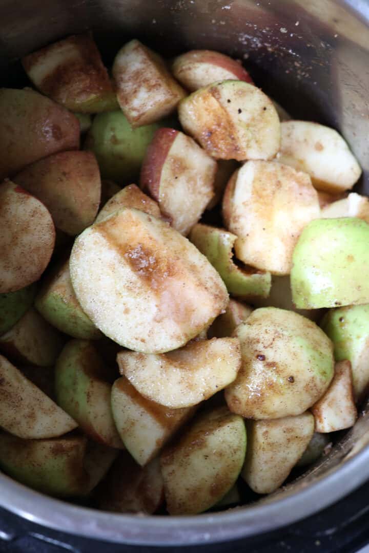 cored apples in a pressure cooker with spices