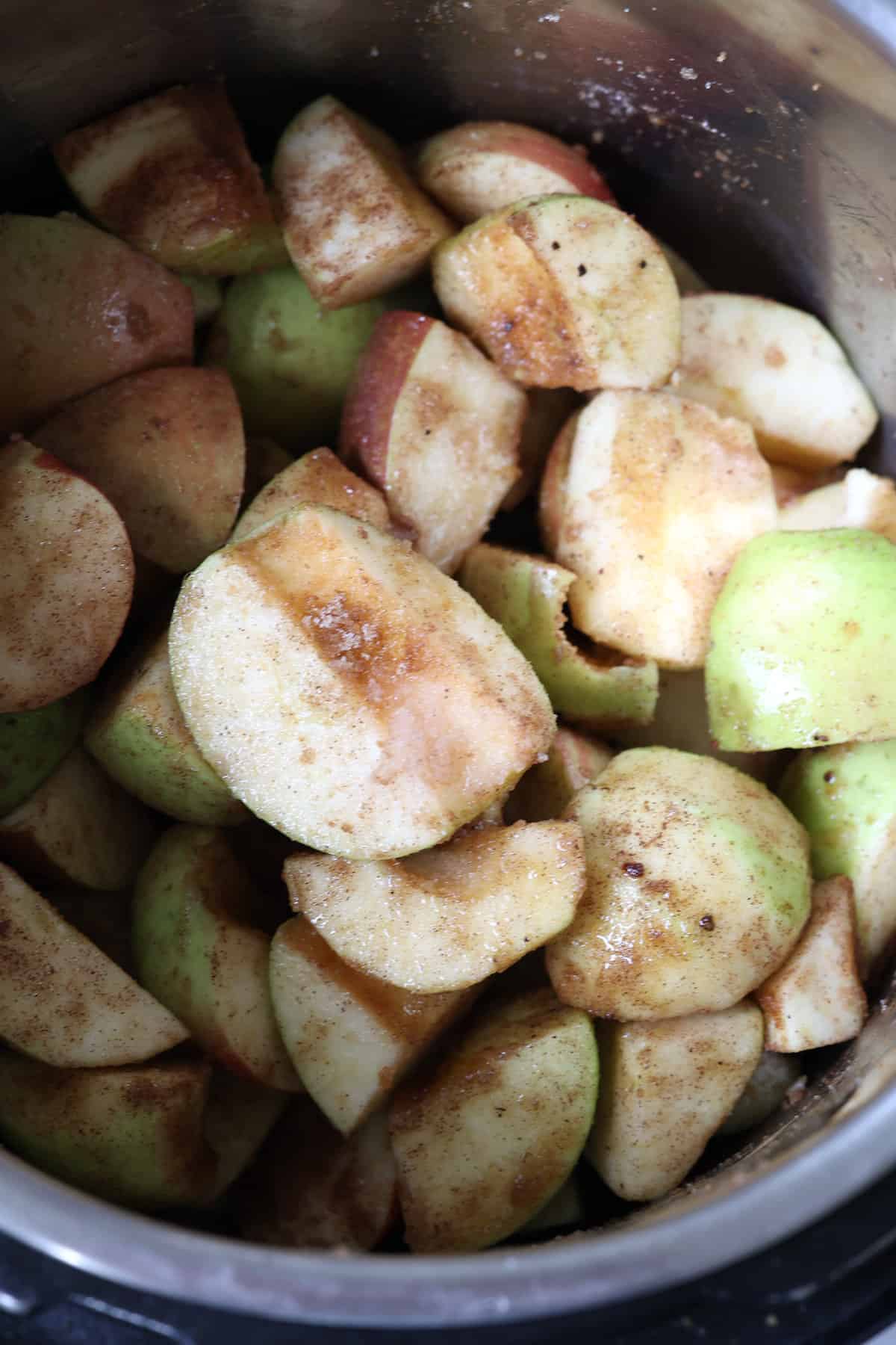 cored apples in a pressure cooker with spices 