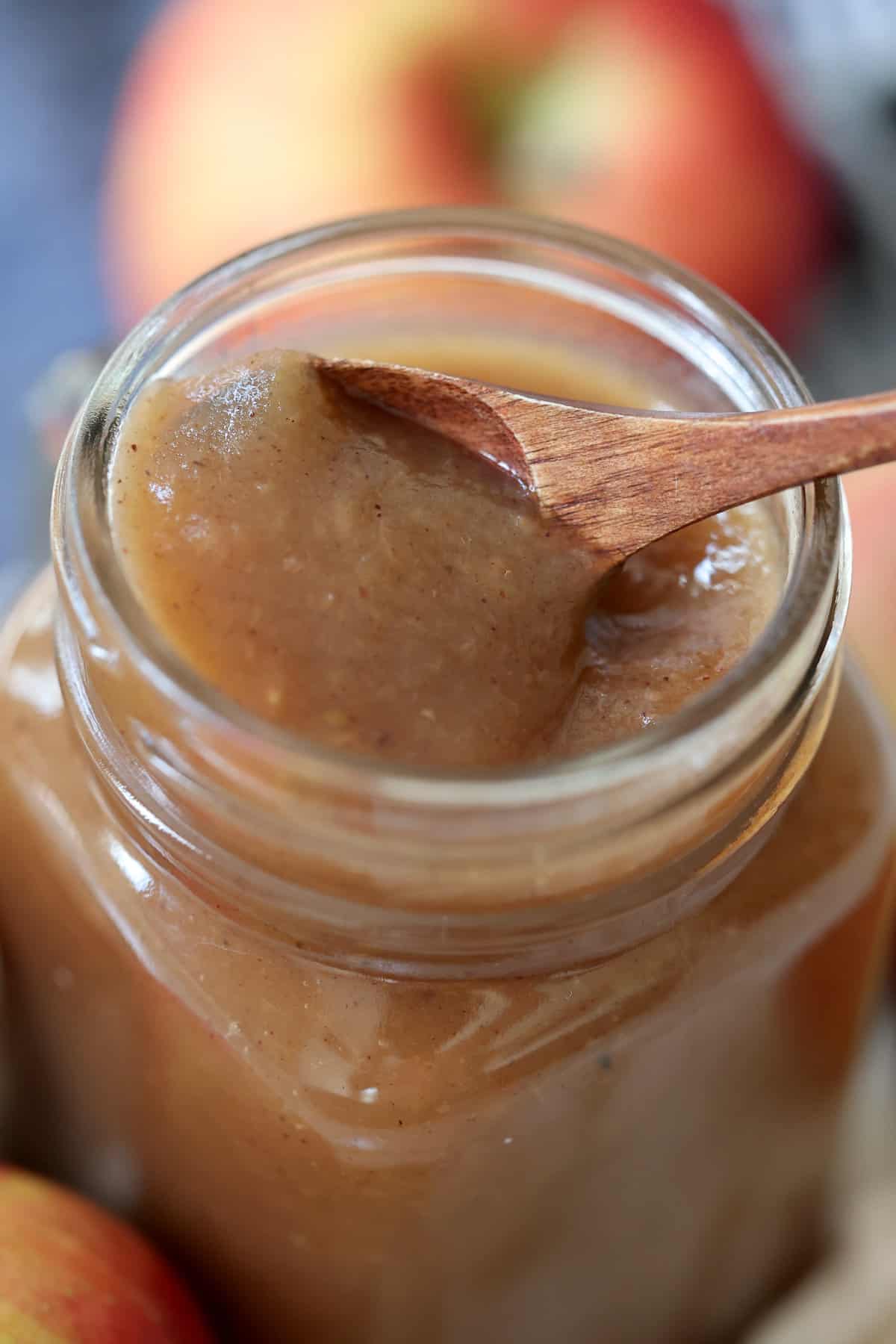 instant pot apple butter close up on a spoon in a mason jar