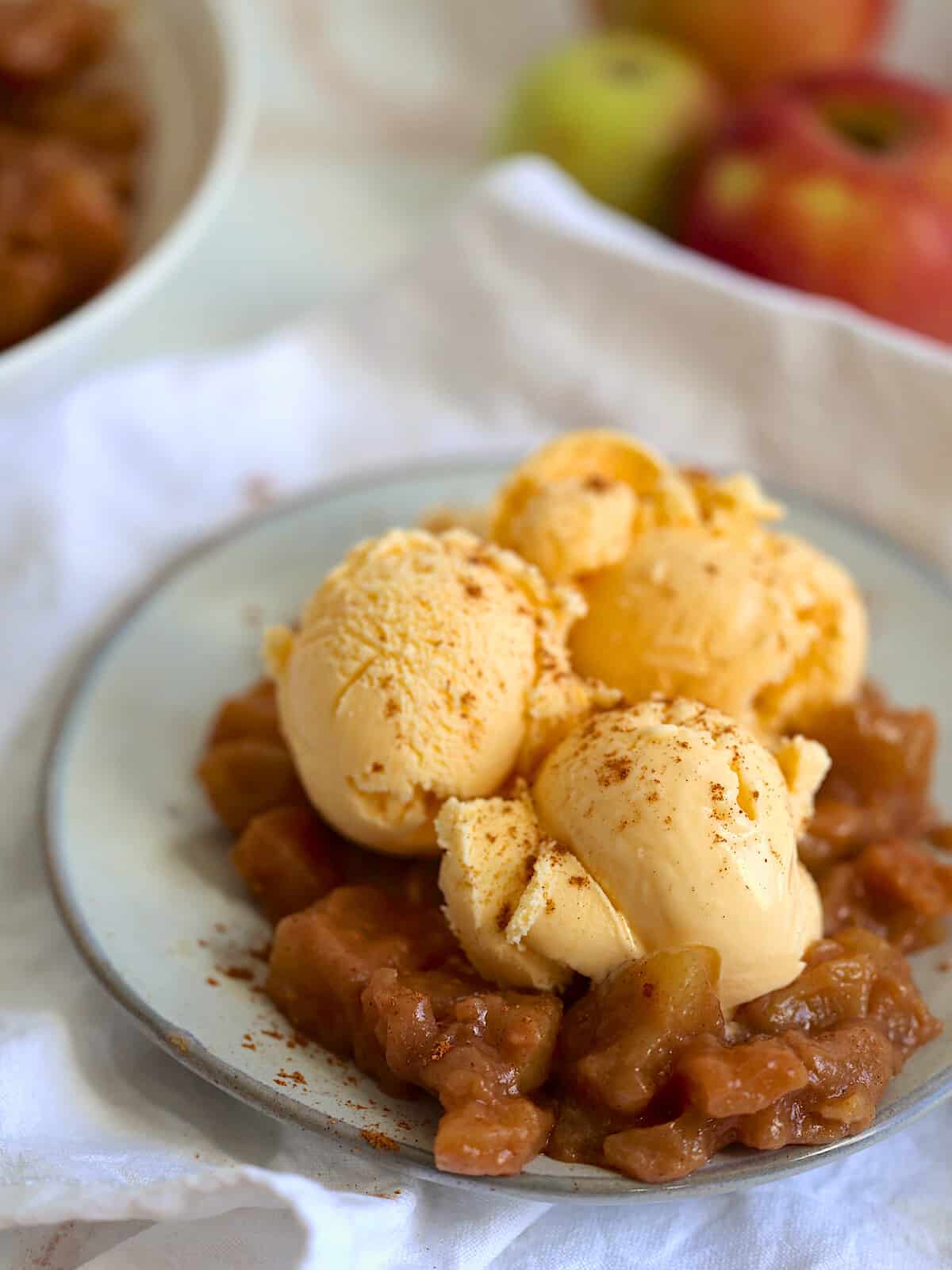 homemade crock pot apple pie filling served with ice cream on top