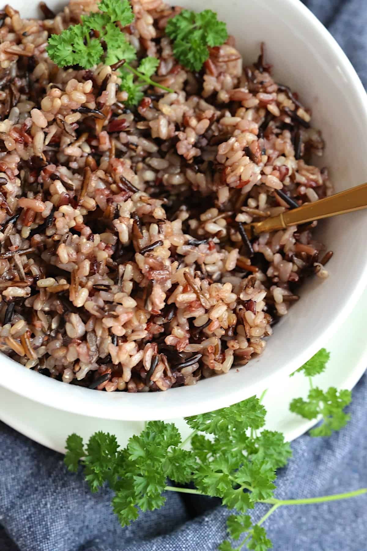 instant pot wild rice blend in a white bowl with parsley