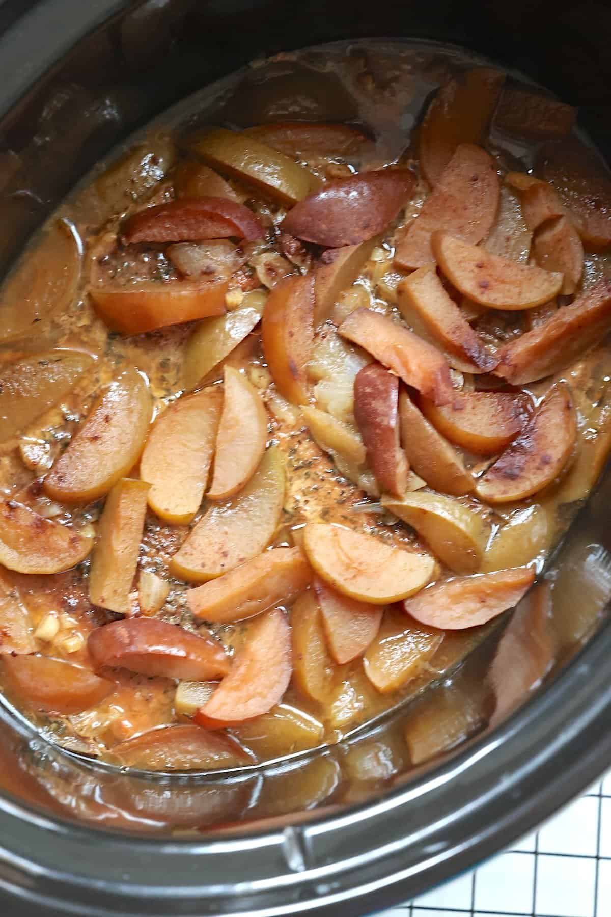cooked apples, onions, pork chops and seasonings in a slow cooker