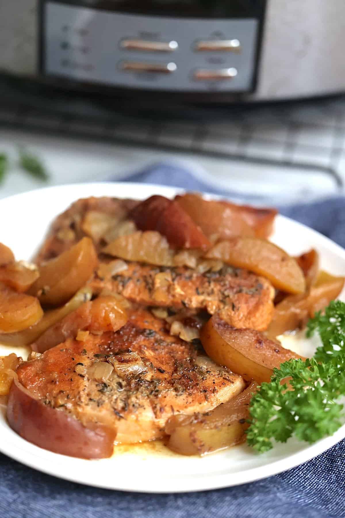 crock pot pork chops and apples on a plate