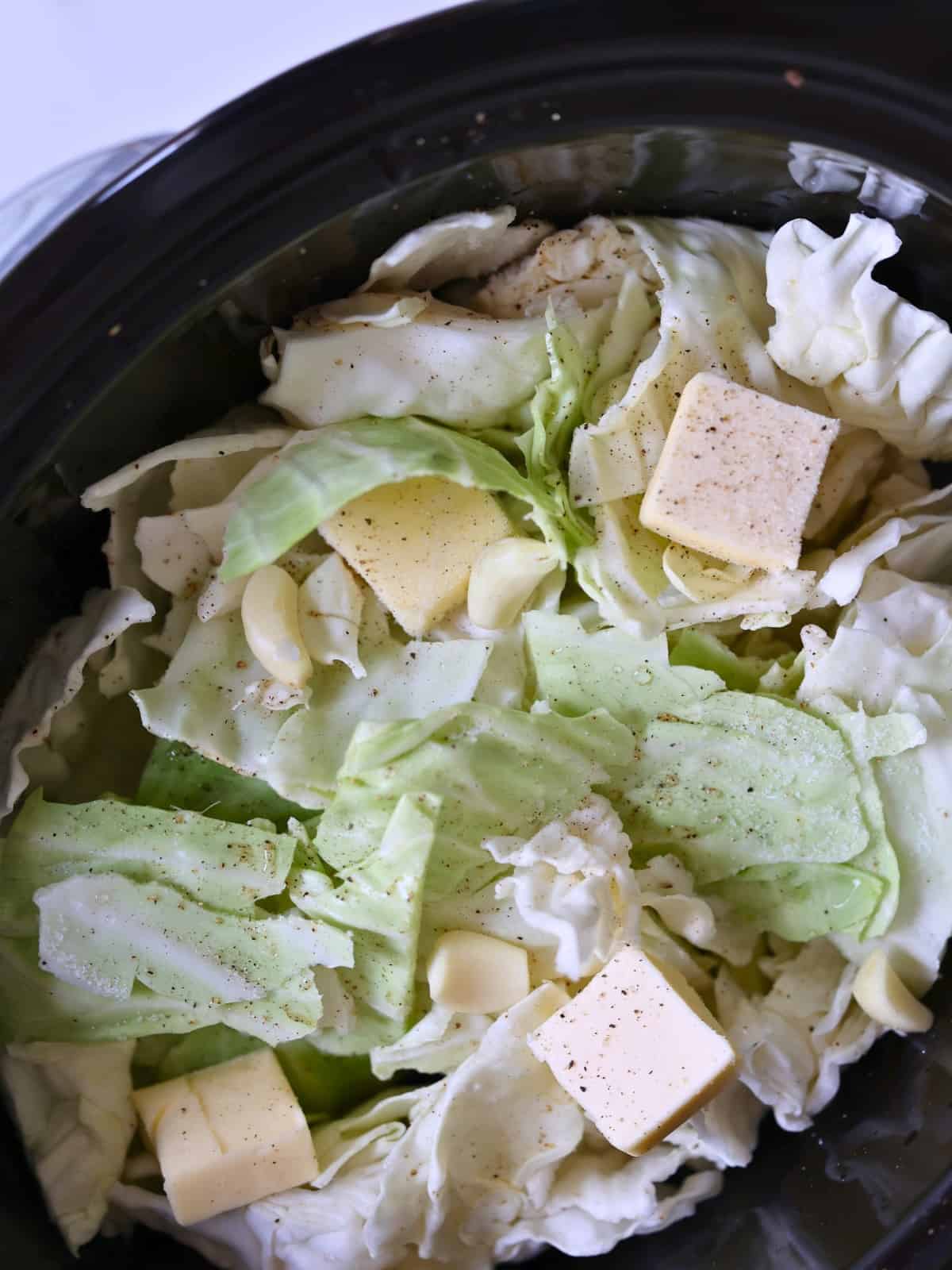 uncooked cabbage leaves and butter in a crock pot. 