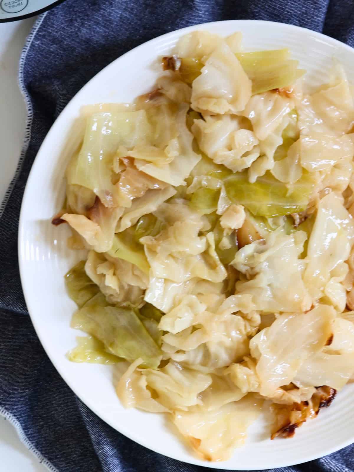 slow cooked cabbage pieces in a white plate