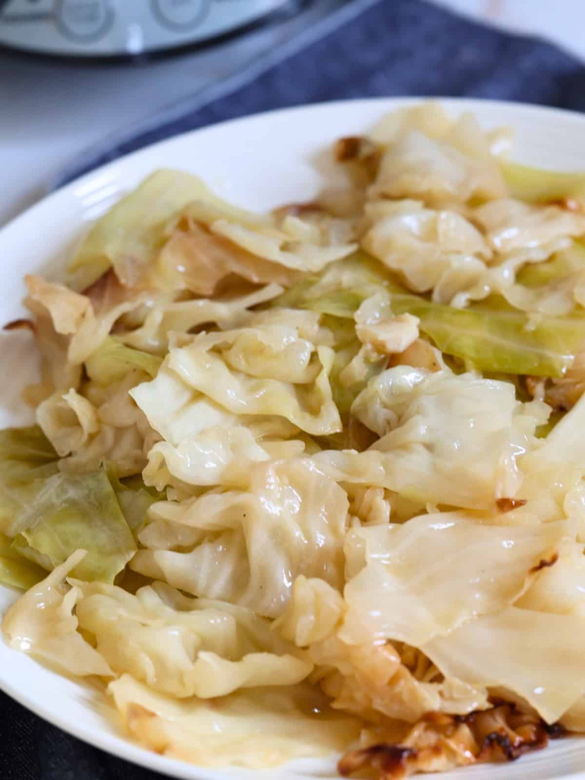 slow cooker cabbage and butter in a white plate