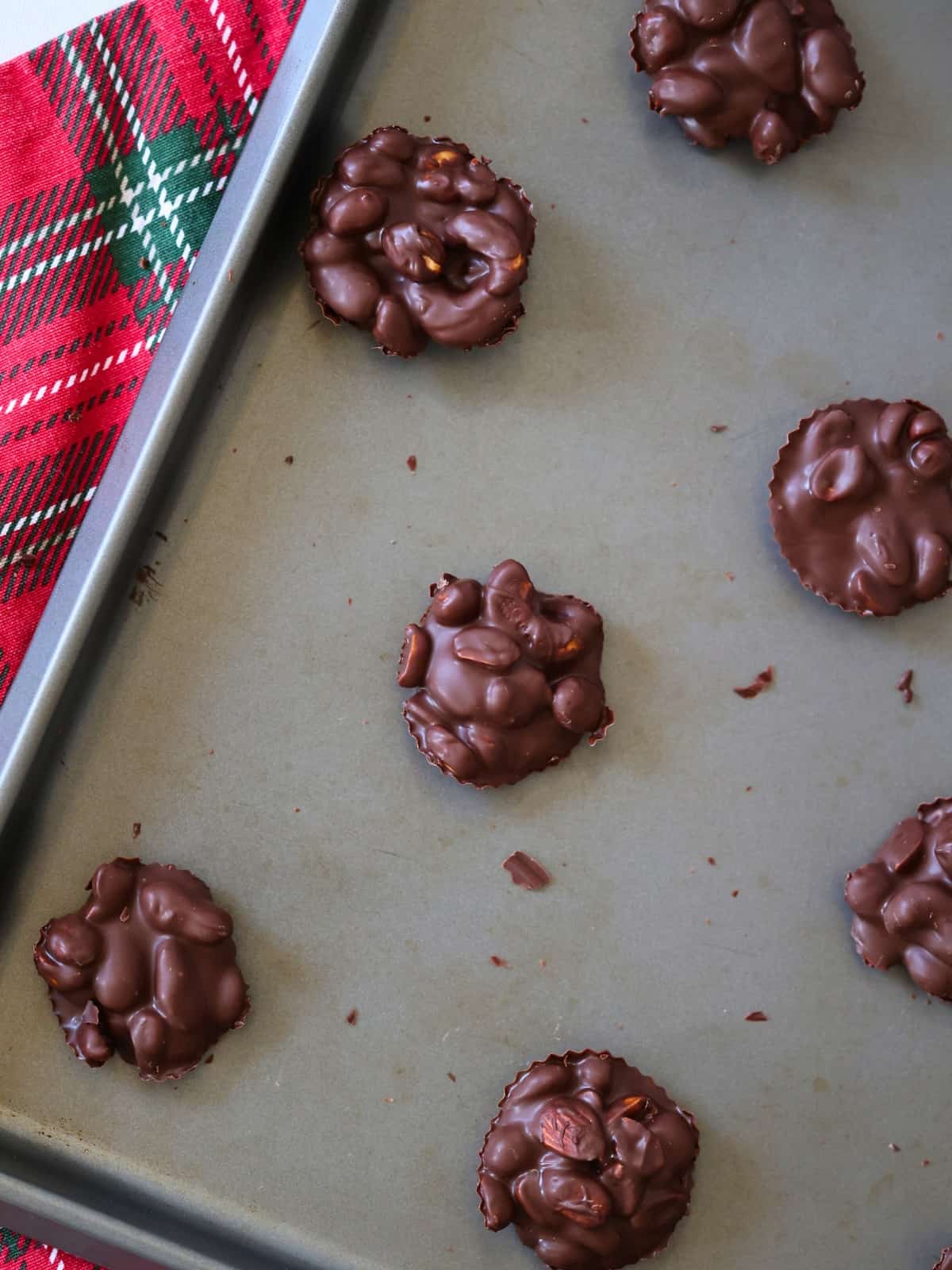 crockpot peanut chocolate clusters on a baking sheet