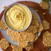 blender hummus with crackers in a bowl