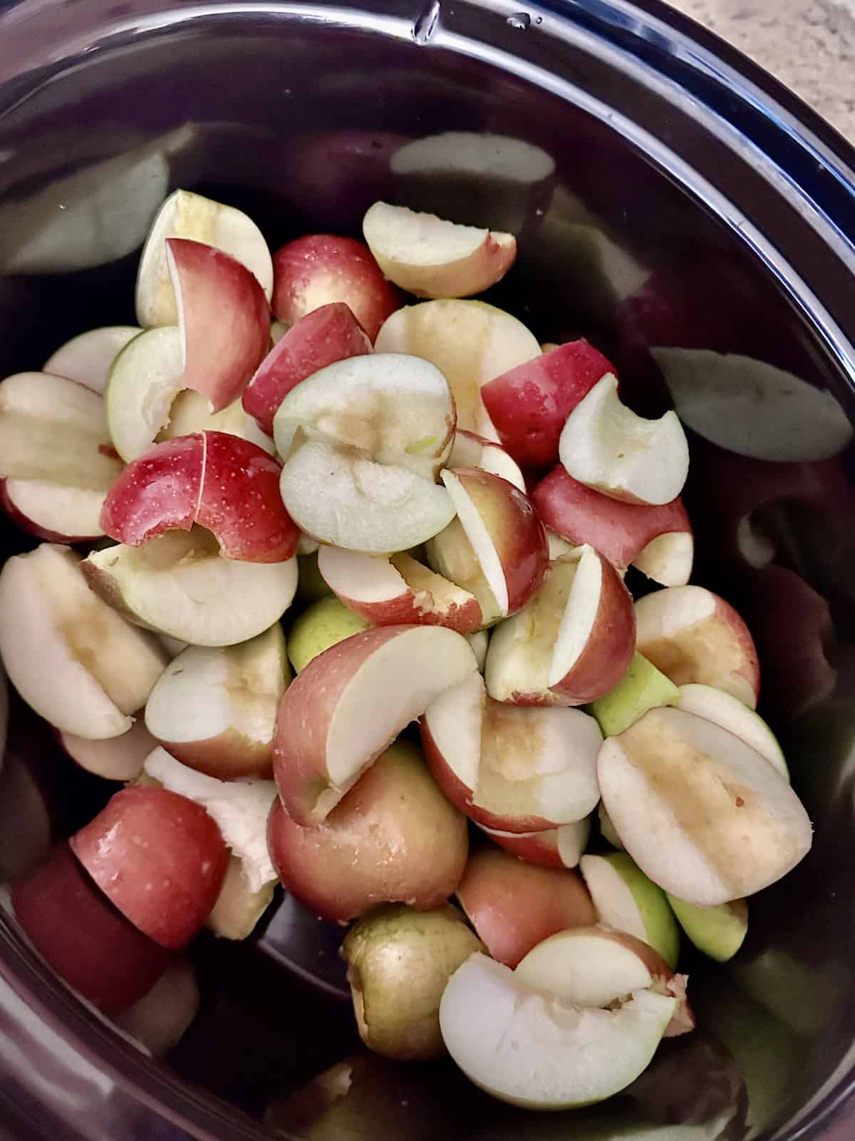 quartered apples in a slow cooker