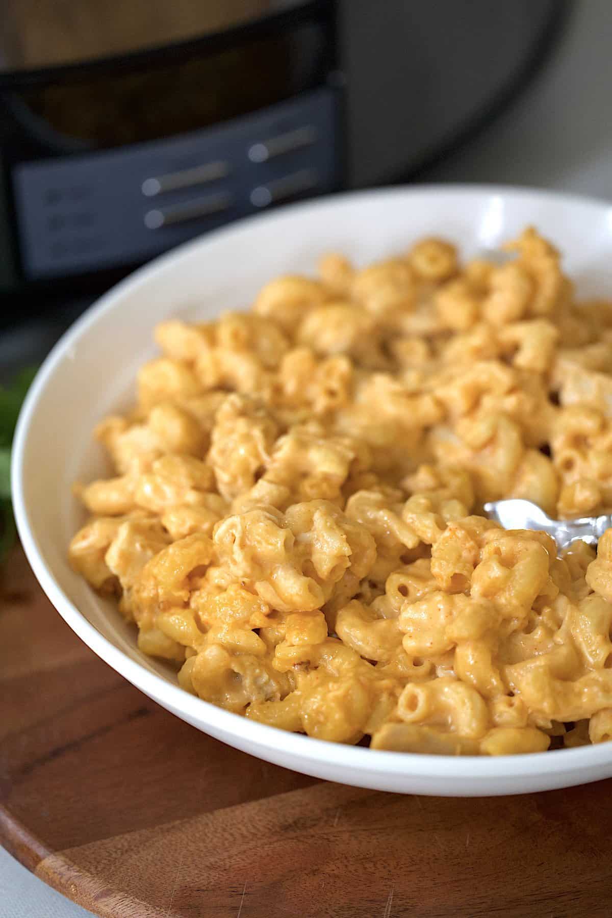 crockpot buffalo chicken macaroni and cheese in a white bowl