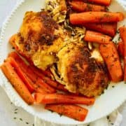 chicken and carrots on a white plate