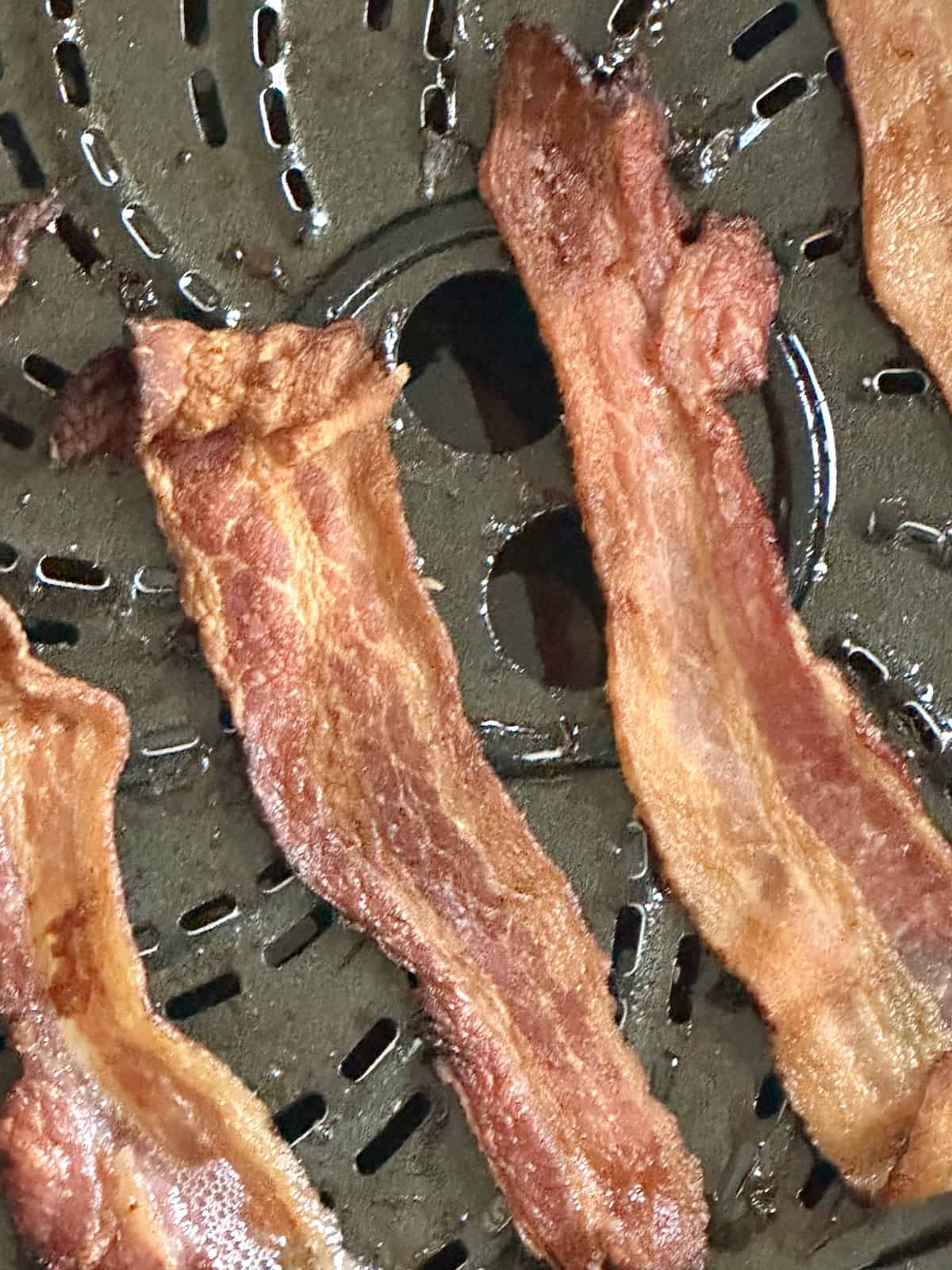 crispy bacon in an air fryer basket