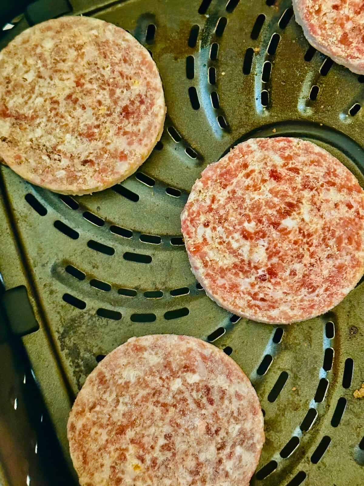sausage patties in an air fryer basket