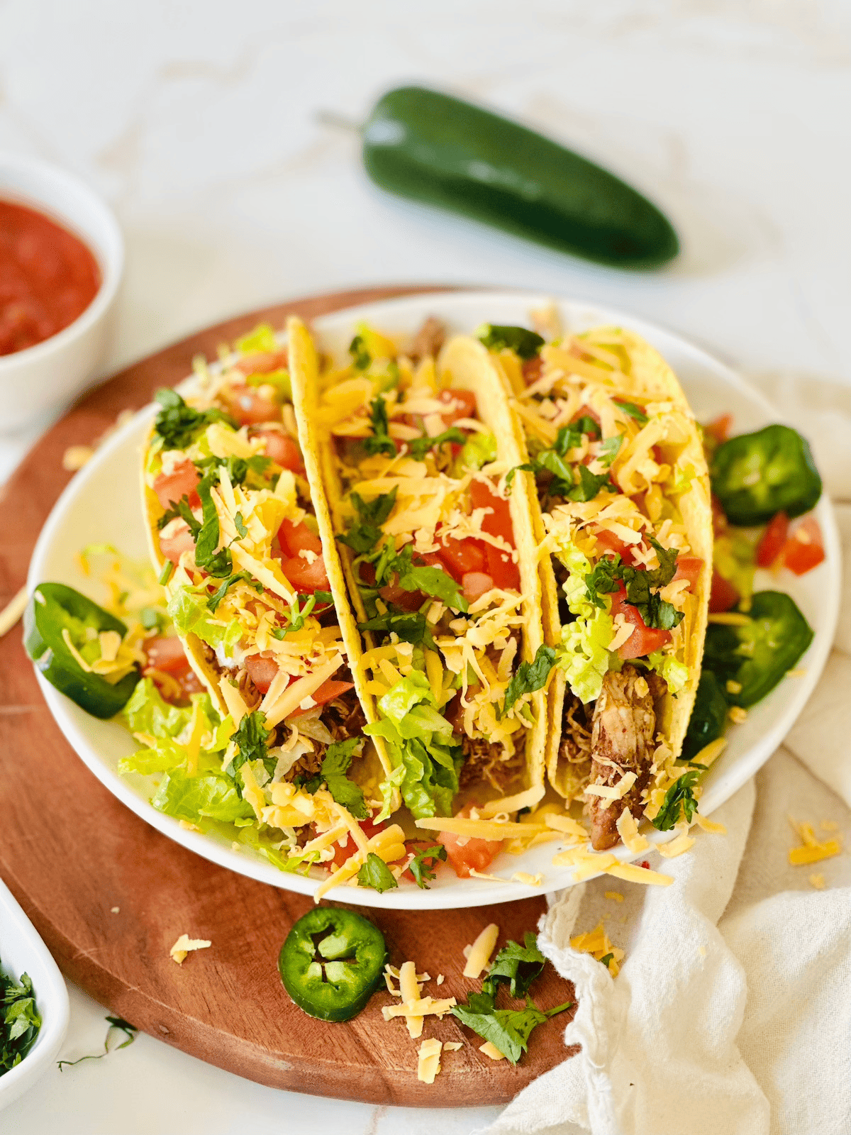 crockpot shredded chicken tacos on a white plate