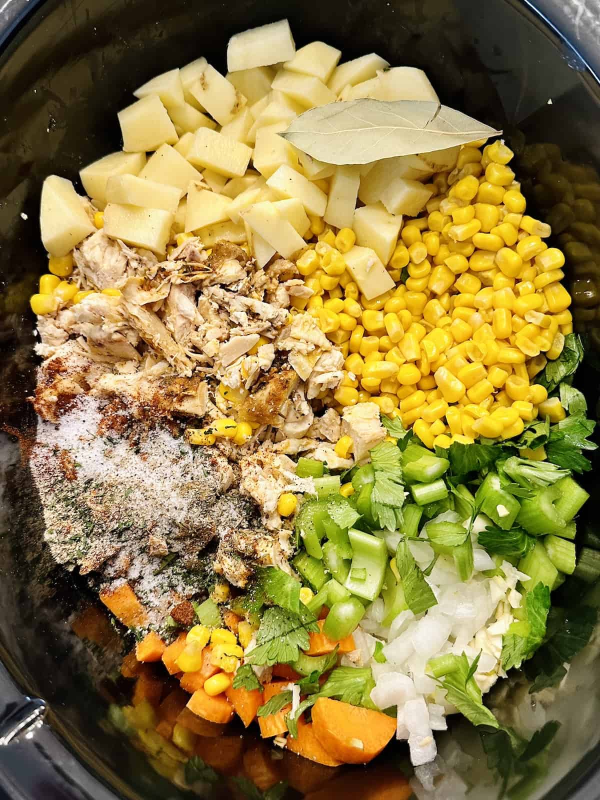 corn, chicken, vegetables, broth and seasonings in a crock pot.