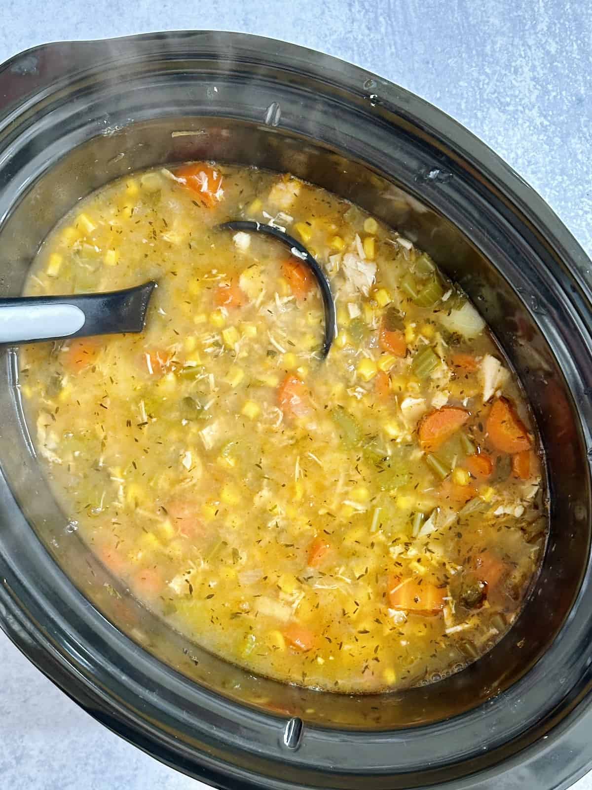 chicken and corn soup in a crock pot.