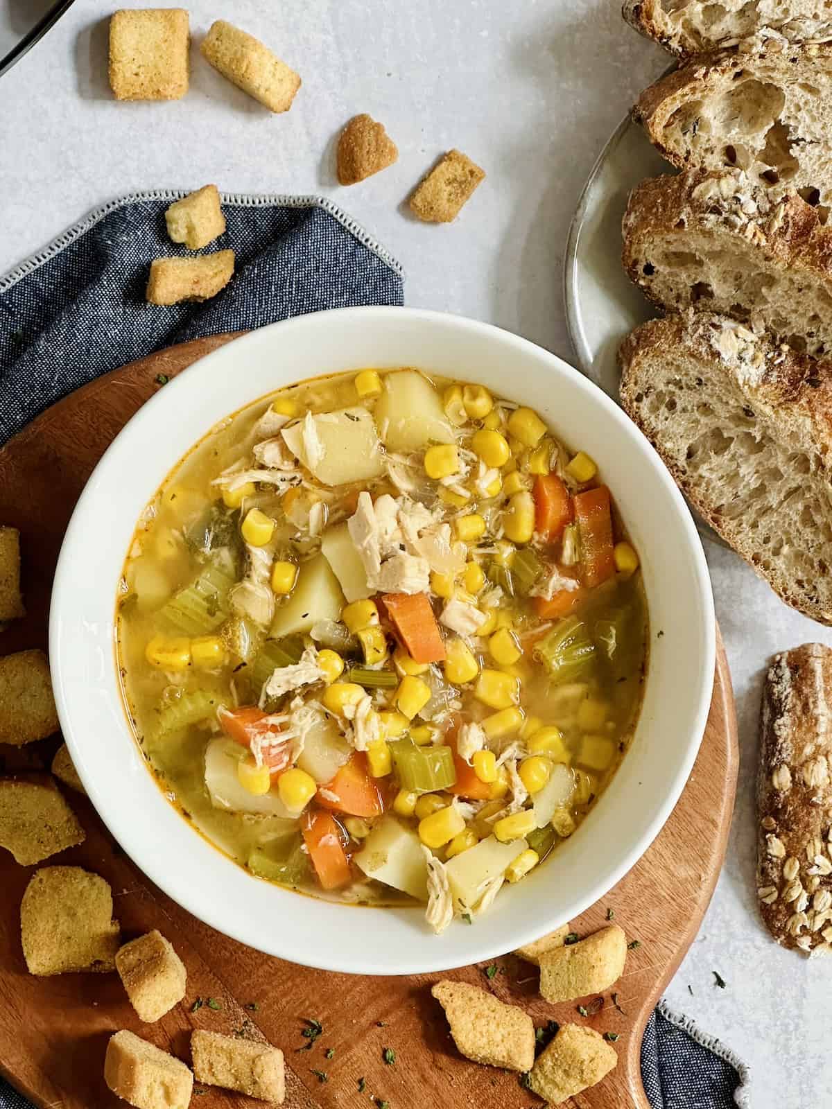 slow cooker chicken corn soup in a bowl with croutons