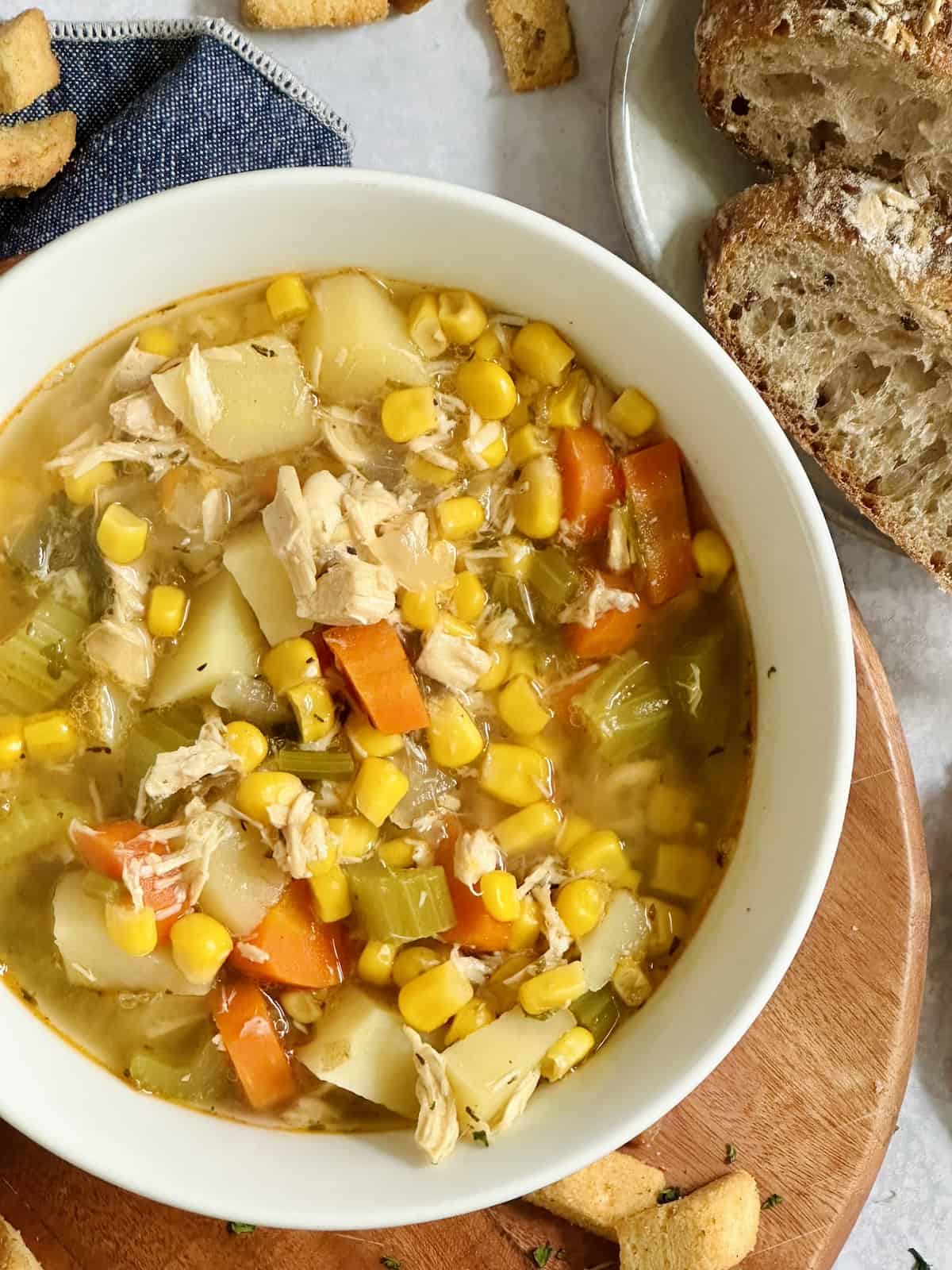 slow cooker chicken and corn soup in a white bowl