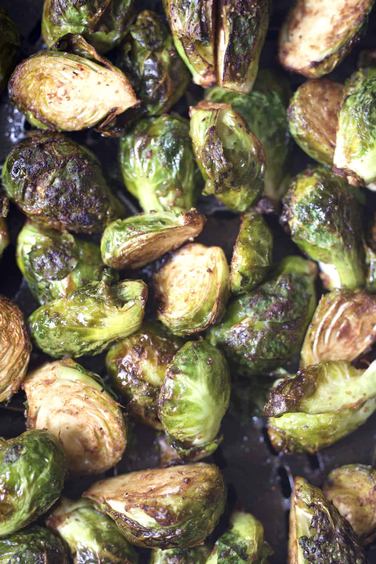 close up of air fryer brussels sprouts with balsamic and parmesan cheese