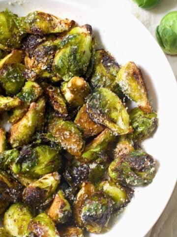 air fryer brussels sprouts with balsamic dressing on a white plate
