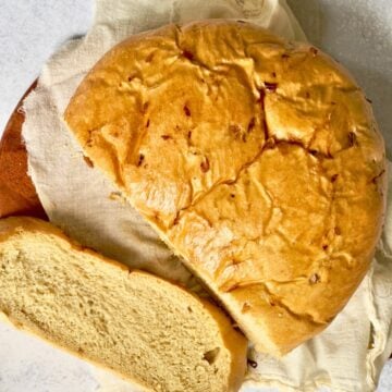 bread machine onion bread sliced on a wooden trivet