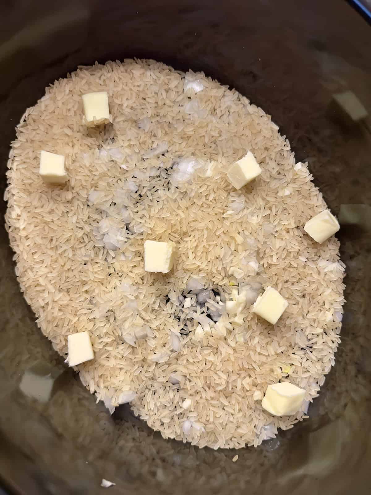 rice, broth and butter in a slow cooker